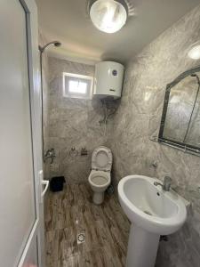 a bathroom with a toilet and a sink at Mai Shekvetili in Shekvetili +16 photos