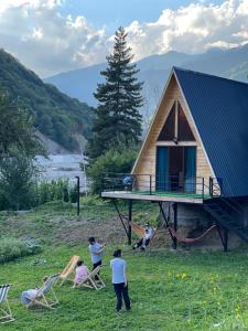 a group of people standing outside of a cabin at Glacier Shoda in Ghebi