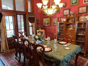 a dining room with a table and chairs at Mansion on The Mile B&B in Indianapolis