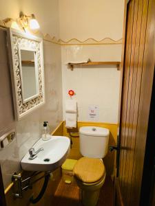 a bathroom with a white toilet and a sink at Venta Judio in Purchena +8 photos