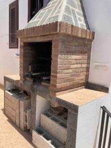 a brick pizza oven sitting next to a building at Mountain View Villa in Playa Blanca