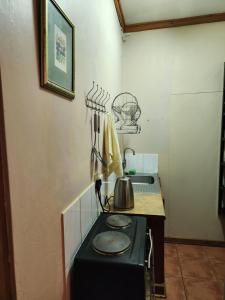 a kitchen with a stove with a tea kettle on it at La Provence Accommodation in Bloemfontein