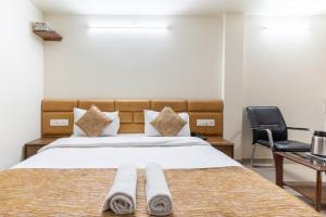 Postel nebo postele na pokoji v ubytování Hotel Sanmati