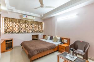 Postel nebo postele na pokoji v ubytování Hotel Sanmati