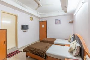 Postel nebo postele na pokoji v ubytování Hotel Sanmati