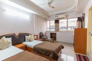 Postel nebo postele na pokoji v ubytování Hotel Sanmati