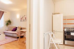a kitchen and a living room with a refrigerator at Free parking Downtown Apartment Boutique Green Garden Unirii in Bucharest