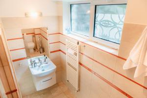 a bathroom with a sink and a toilet and a window at Free parking Downtown Apartment Boutique Green Garden Unirii in Bucharest +53 photos
