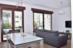 a living room with a couch and a glass table at Super Villa for vacation Gjiri i Lalzit in Draç