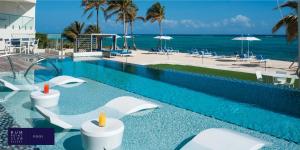 a swimming pool with a view of the beach and the ocean at Rum Point Club Resort Luxury Beachfront Condos by Grand Cayman Villas & Condos in Driftwood Village