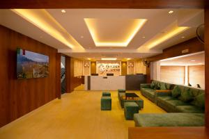 a living room with a couch and a table at Galaxy Golden Fortune Hotel in Bangalore