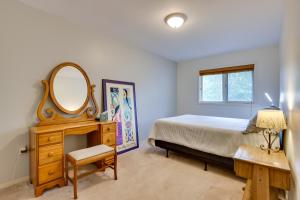 a bedroom with a bed and a mirror and a table at 2 Mi to Ski Resort Mountain Home with Hot Tub! in Frisco