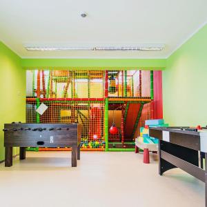 a play room with a ping pong table at Harmónia Hotel Sárvár in Sárvár