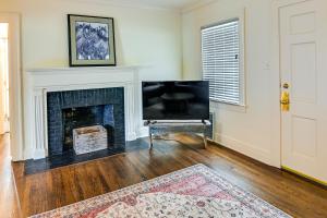 a living room with a fireplace and a chair at Lexington Condo with Balcony 1 Mi to UK Campus! in Lexington