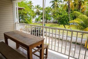 a porch with a wooden bench on a balcony at Rocky Cay Lodging in San Andrés