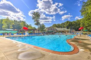 a large swimming pool at a resort with people in it at Poconos Getaway with Indoor and Outdoor Pool Access! in Gouldsboro