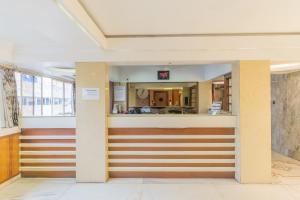a lobby of a hospital with a counter in a building at Hotel Sanmati in Ahmedabad