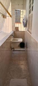 a bathroom with a sink and a staircase at Apartamento confortável in Rio de Janeiro