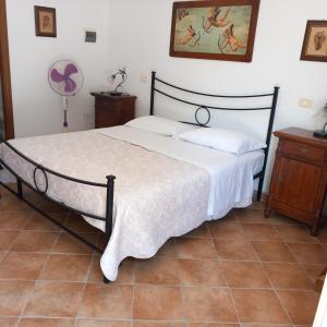 een slaapkamer met een groot bed met een witte sprei bij Agriturismo la Martina in Macchiascandona