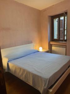 a bedroom with a large bed with a blue blanket at Il Belvedere sul Conero in Potenza Picena