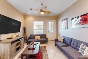 a living room with a large flat screen tv at Escape Condominiums #7 in South Padre Island