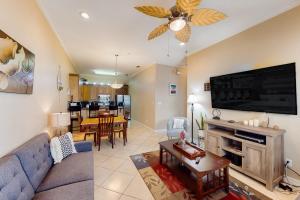 a living room with a couch and a flat screen tv at Escape Condominiums #7 in South Padre Island