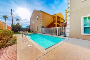 a swimming pool in front of a house at Escape Condominiums #7 in South Padre Island
