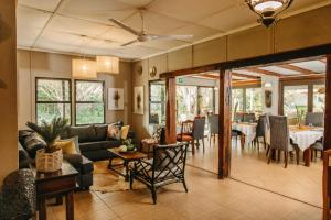 Biweda Nguni Lodge في Mkuze: غرفة معيشة مع أريكة وطاولة