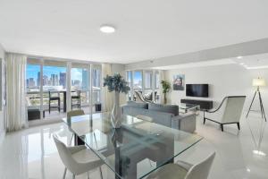 a living room with a glass table and chairs at Meet Me in Miami! Impressive Miami Skyline Views in Miami