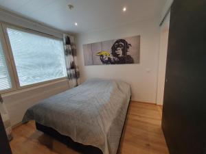 a bedroom with a bed and a large window at River View City Apartment in Rovaniemi