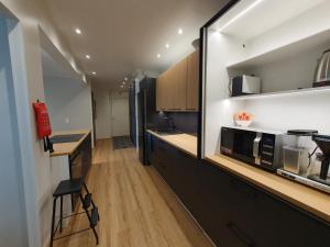 a kitchen with black cabinets and a counter top at River View City Apartment in Rovaniemi