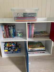 a book shelf filled with lots of books at Høgset in Austefjorden