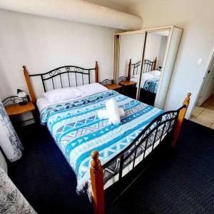 a bedroom with a large bed and two mirrors at Villa 2 Pool Spa Beach Sea! in Mandurah