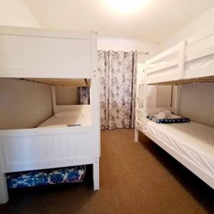 a bedroom with two bunk beds and a window at Villa 2 Pool Spa Beach Sea! in Mandurah