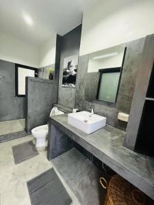 a bathroom with a sink and a toilet at Sunset resorts and bar in Ban Nong Chaeng +33 photos