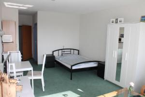 ブラズィリアンにあるFerienappartement K312 für 2-3 Personen in Strandnäheのベッドルーム1室(ベッド1台、テーブル、椅子付)