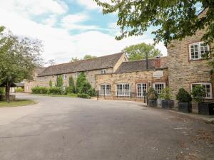 an empty driveway in front of a brick building at Clipsham in Cottesmore