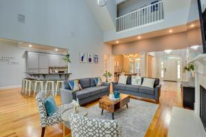 a living room with a couch and a table at Grand Lakefront Home in Hartwell with Game Room! in Hartwell