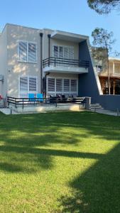 a house with a lawn in front of it at Sunset Bay Villa at Gjiri Lalzit Durres in Durrës