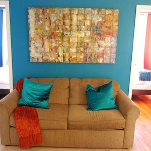 a couch with two blue pillows in a living room at 4BR in Manhattan in New York