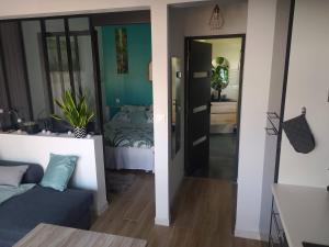 a living room with a couch and a bed in a room at Maisonnette in Biscarrosse