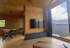 a living room with a flat screen tv on the wall at Chalet Smreky in Telgárt