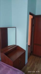 a bedroom with a dresser with a mirror on it at Nairi in Sevan