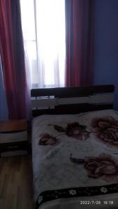 a bedroom with a bed with flowers on it at Nairi in Sevan