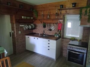 a kitchen with a sink and a stove at Sobreirinha in Coruche +7 photos