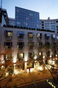 a person standing in front of a building at night at Silken Axis Vigo in Vigo