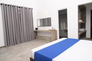 Postel nebo postele na pokoji v ubytování Everdew Kandy Rooms