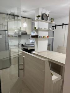 a kitchen with a counter with a table in it at Departamento céntrico 2 dormitorios in San Nicolás de los Arroyos
