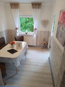 a dining room with a table and a window at 5x Fuchs-Dobry Balkon-Apartments 40qm-65qm in Oberhausen