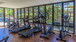 a row of treadmills in a gym with windows at Relife Windy by Nataly in Phuket Town
